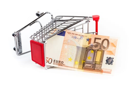 Shopping cart with 50 euro bill inside. Shopping cart is upturned, concept symbol of bankruptcy, crisis and other.
