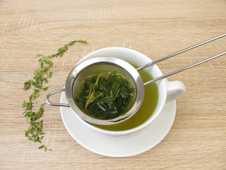 Freshly brewed hemp tea in a tea strainer