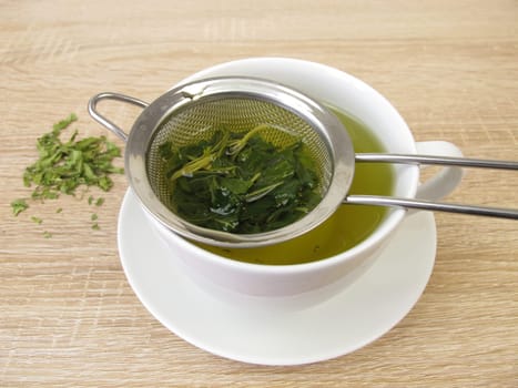 Freshly brewed hemp tea in a tea strainer