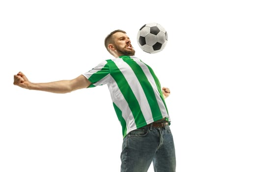 Irish fan celebrating on white background. The young man in soccer football uniform as winner with ball isolated at white studio. Fan, support concept. Human emotions concept.