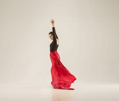 Modern ballet dancer exercising in full body on white studio background. Ballerina or female dancer with silk fabric dancing on white studio background. Caucasian model on pointe shoes