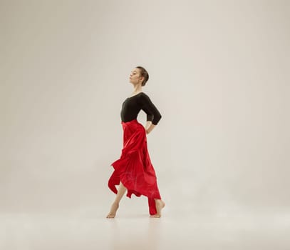 Modern ballet dancer exercising in full body on white studio background. Ballerina or female dancer with silk fabric dancing on white studio background. Caucasian model on pointe shoes