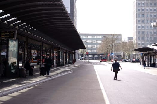 Koblenz,Germany – April 08,2018: People sit under the covered shelters of the bus station in the city center on April 8,2018 in Koblenz.