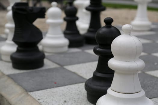 Black and white king on a chess board in open air