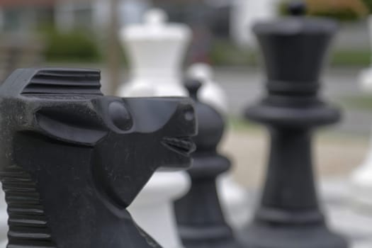 Black and white king on a chess board in open air