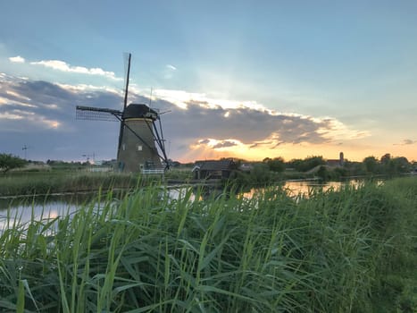 Beautiful dutch windmill landscape at the famous Kinderdijk canals, UNESCO world heritage site