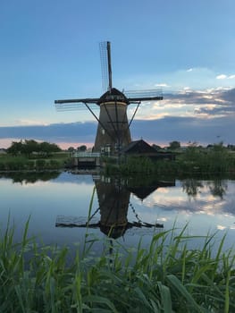 Beautiful dutch windmill landscape at the famous Kinderdijk canals, UNESCO world heritage site