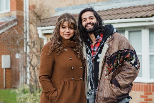 Portrait of a happy mid adult man and his mother on the driveway of their home.