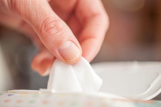 Hand picked a wet wipes in package box, Wet wipes in a woman's hand