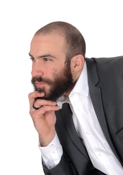A young businessman sitting with his hand on his chin in a suit and .beard and mustache, isolated for white background.