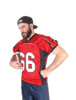 A close-up image of a football player in his jersey, holding his football.and looking down, thinking, isolated for white background.
