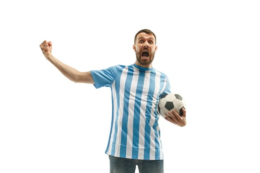 The young Argentinean fan celebrating on white background. The young man in soccer football uniform as winner isolated at white studio. Fan, support concept. Human emotions concept.