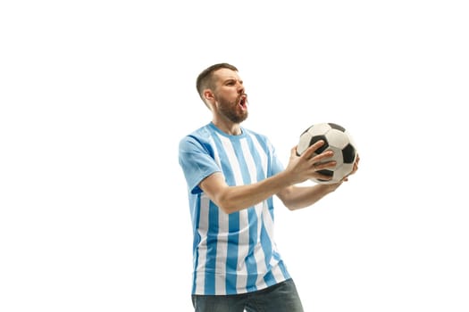 The young Argentinean fan celebrating on white background. The young man in soccer football uniform as winner isolated at white studio. Fan, support concept. Human emotions concept.