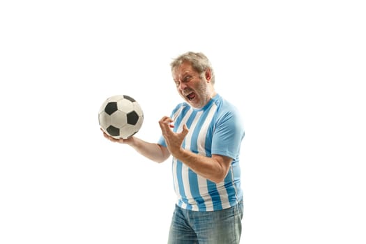 The senior Argentinean fan celebrating on white background. The mature man in soccer football uniform as winner isolated at white studio. Fan, support concept. Human emotions concept.
