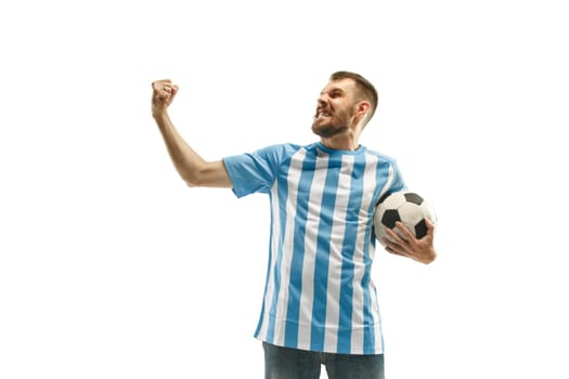 The young Argentinean fan celebrating on white background. The young man in soccer football uniform as winner isolated at white studio. Fan, support concept. Human emotions concept.