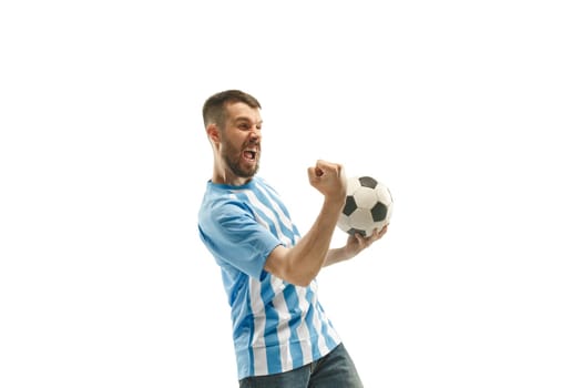 The young Argentinean fan celebrating on white background. The young man in soccer football uniform as winner isolated at white studio. Fan, support concept. Human emotions concept.
