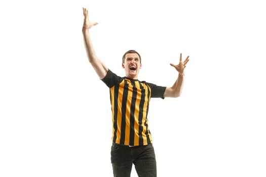 The young Belgian fan celebrating on white background. The young man in soccer football uniform as winner isolated at white studio. Fan, support concept. Human emotions concept.