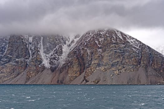 Granite Peaks in the Clouds on the Coast in Sam Ford Fjord on Baffin Island in Nunavut, Canada