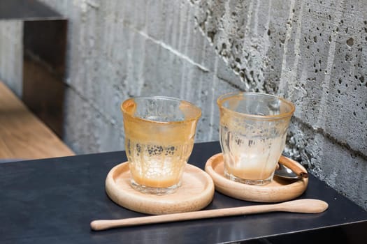 Finished drink of latte coffee on wooden saucer, stock photo