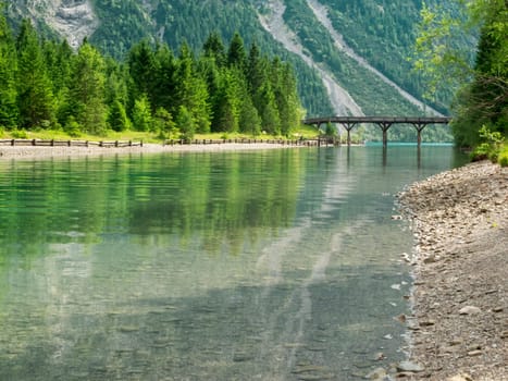 Pedestrian bridge over the canal between Plansee and Heiterwanger See in Austria in summer 2016.