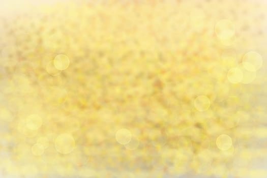 Abstract colorful bright texture bokeh background with golden sheen.