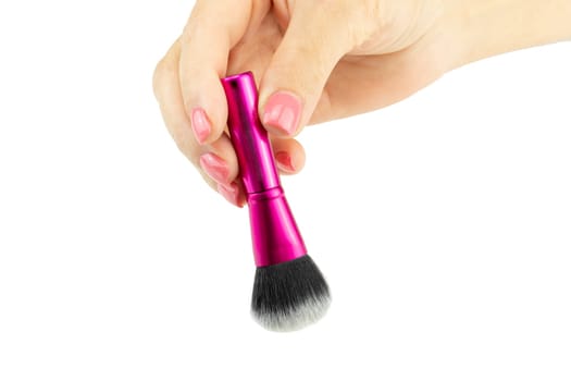 Closeup of female hand is holding professional makeup brush. Concept beauty.