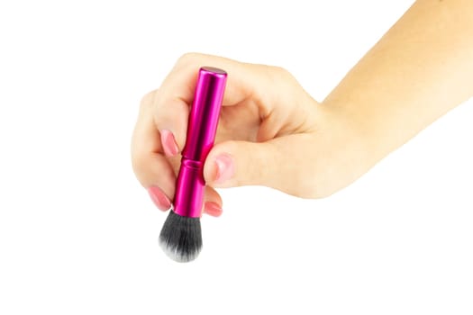 Closeup of female hand is holding professional makeup brush. Concept beauty.