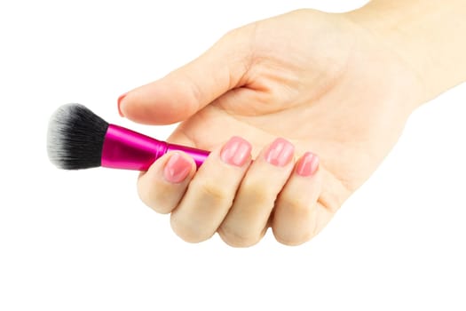 Closeup of female hand is holding professional makeup brush. Concept beauty.