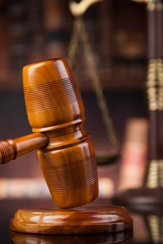 Law theme, mallet of the judge, wooden desk, books