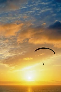 Glider over Pacific Ocean at sunset