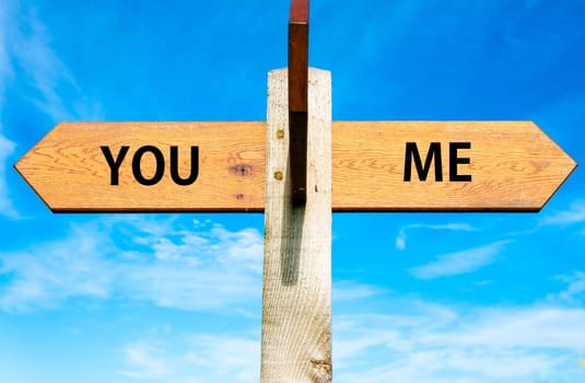 Blank wooden signpost with two arrows over clear blue sky with copy space, just add your text here