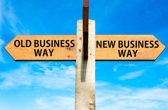 Blank wooden signpost with two arrows over clear blue sky with copy space, just add your text here