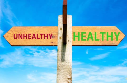 Blank wooden signpost with two arrows over clear blue sky with copy space, just add your text here