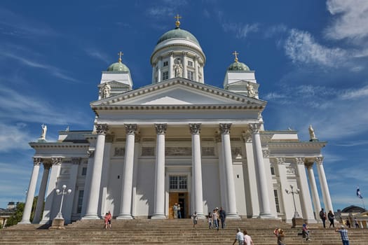 HELSINKI, FINLAND - JULY 10, 2017: Visitors entering the Cathedral of the Diocese of Helsinki, finnish Evangelical Lutheran church, located in the neighborhood of Kruununhaka in Helsinki, Finland