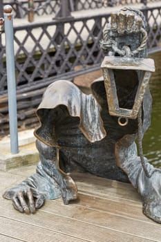 KLAIPEDA, LITHUANIA - JULY 05, 2017: The Black Ghost bronzed sculpture (designed by Svajunas Jurkus and Sergejus Plotnikovas). Danes river quay. Klaipeda Old Town residential district. Lithuania