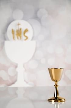 Holy communion a golden chalice, composition isolated on white
