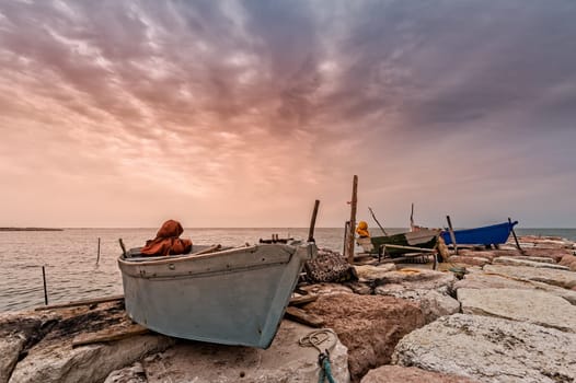 Fishing boat moored on cliff at sunset. Venice,Italy.