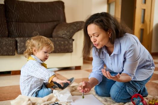 A heartwarming moment of a mother and her young child enjoying creative learning indoors, emphasizing care, education, and family bonding.