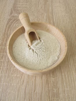 Banana flour from green plantains in a wooden bowl