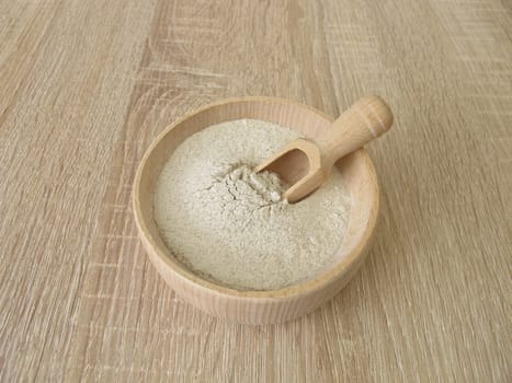 Banana flour from green plantains in a wooden bowl