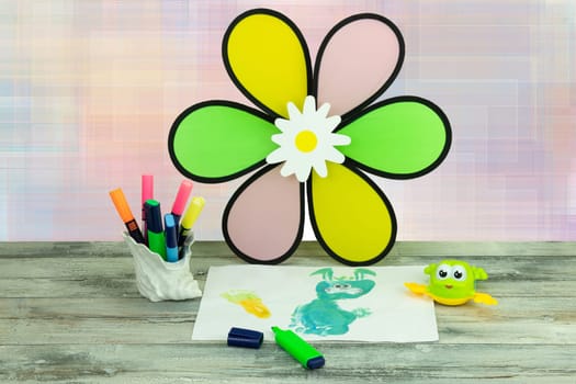 Happy childrens day. Workplace from child is painting his mother a bunny picture.