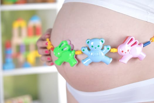 Pregnant woman with a toy