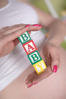 Wooden toy cubes with letters, Baby, Pregnancy concept