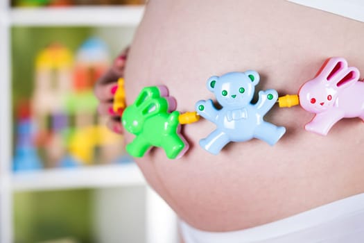 Pregnant woman with a toy