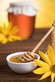 Sweet honey in the comb, glass jar on wooden background