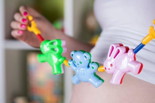 Pregnant woman with a toy