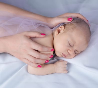 Newborn baby hand holding mother