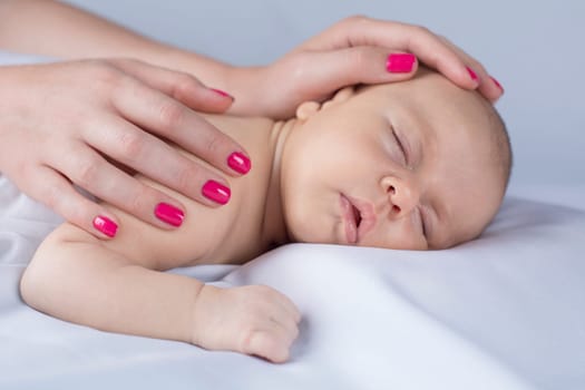 Newborn baby hand holding mother