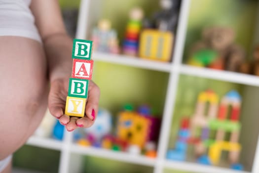 Wooden toy cubes with letters, Baby, Pregnancy concept
