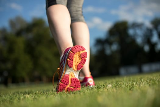 Runner feet running on road closeup on shoe